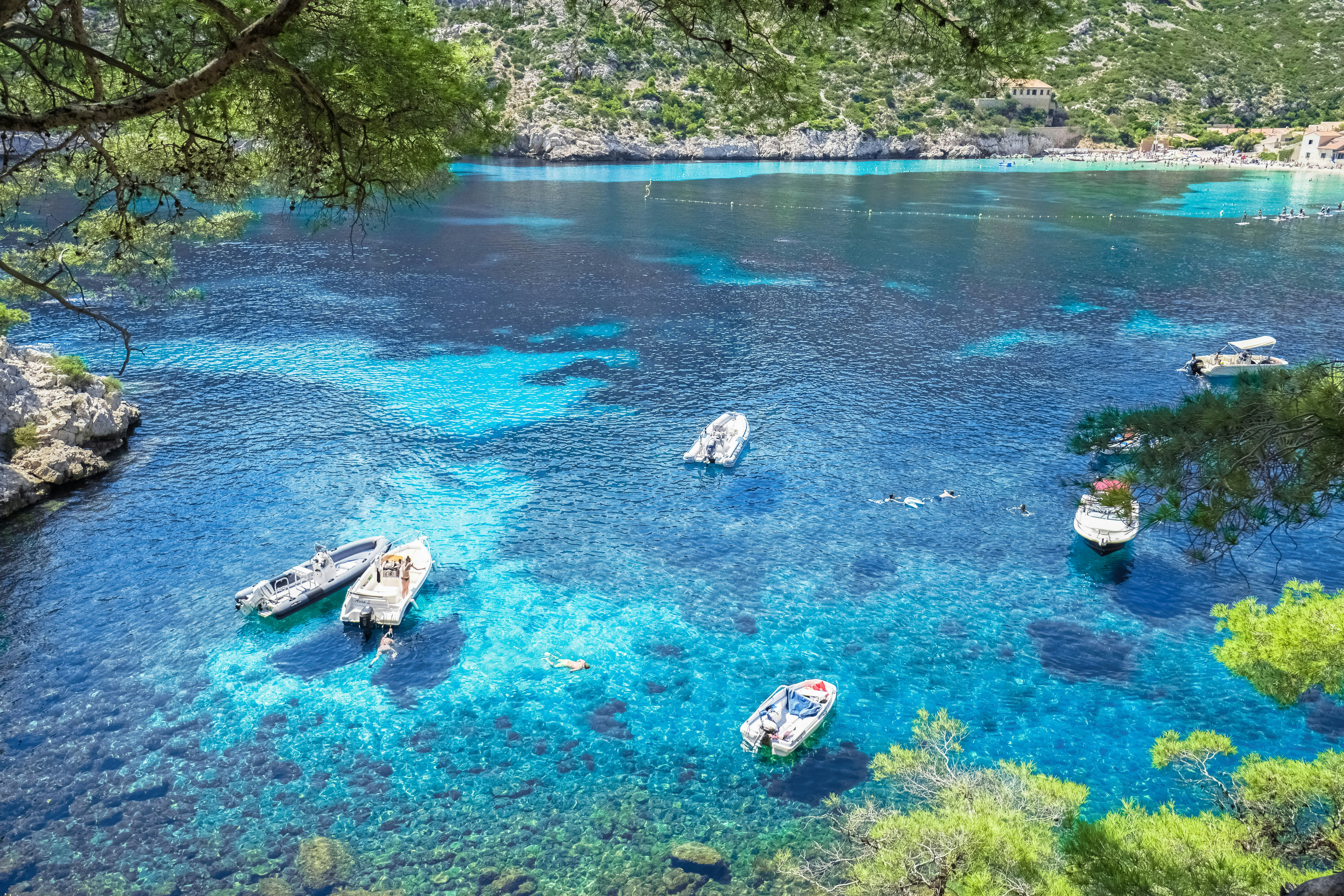 white and brown boat on blue body of water during daytime